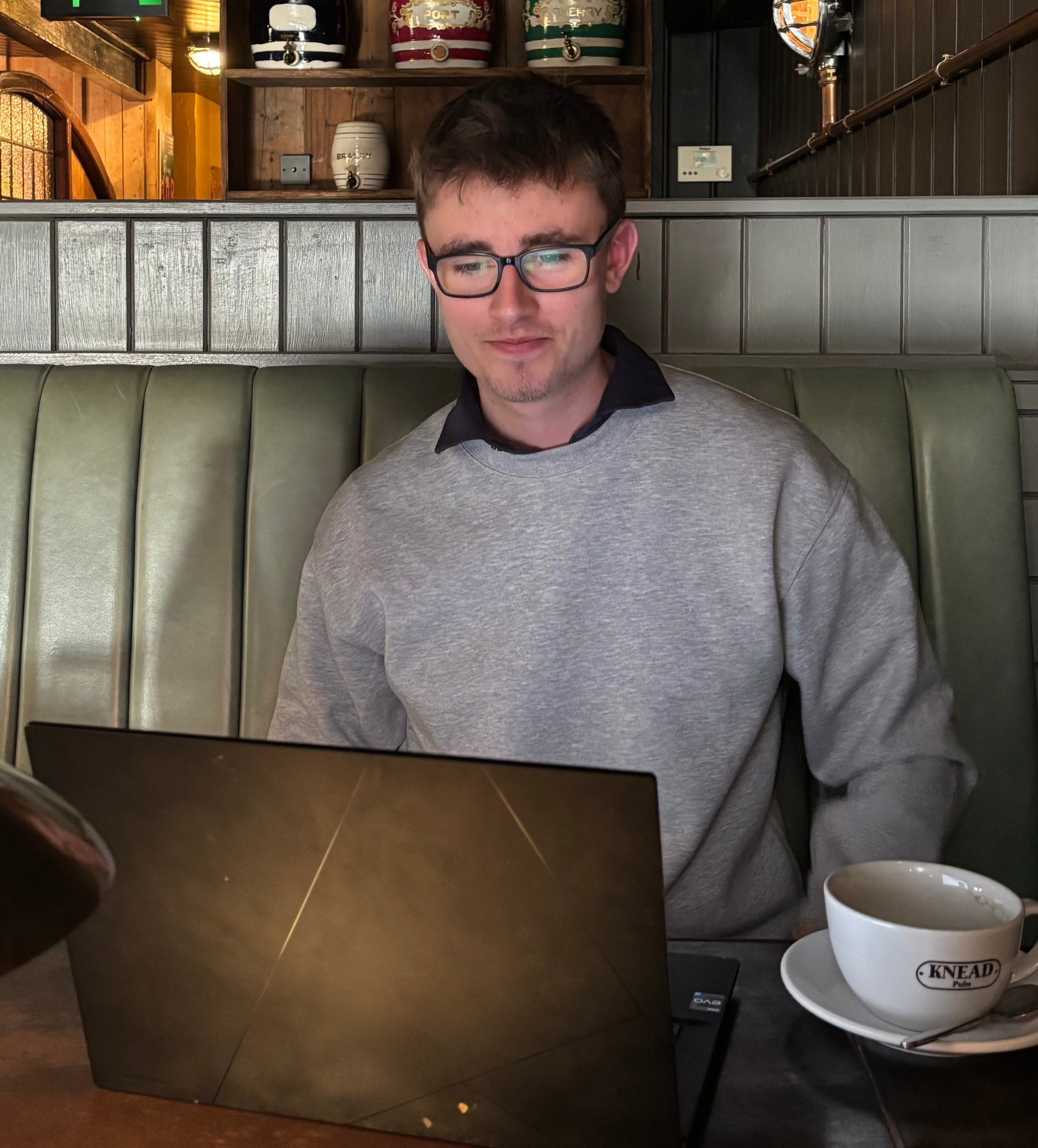 Ollie Henson, founder of Reforge Media, working on a laptop